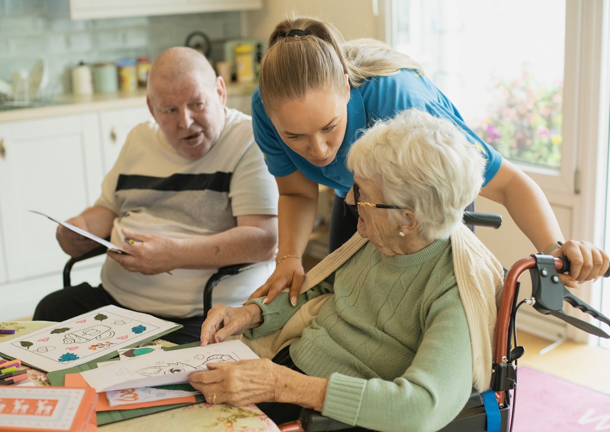 Caregiver supporting senior residents during an activity