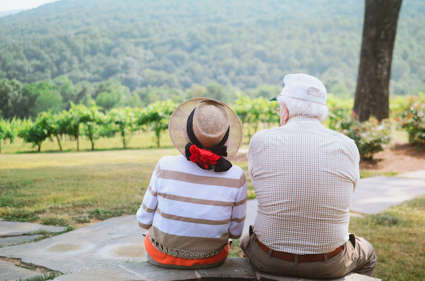 Older couple relaxing in the garden of an assisted living community